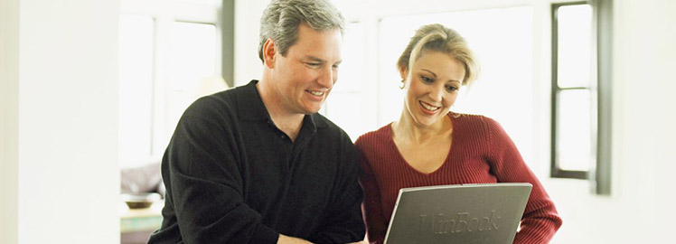 couple in a front of computer